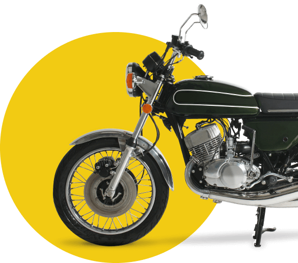 A black & silver cruiser motorcycle behind a yellow background